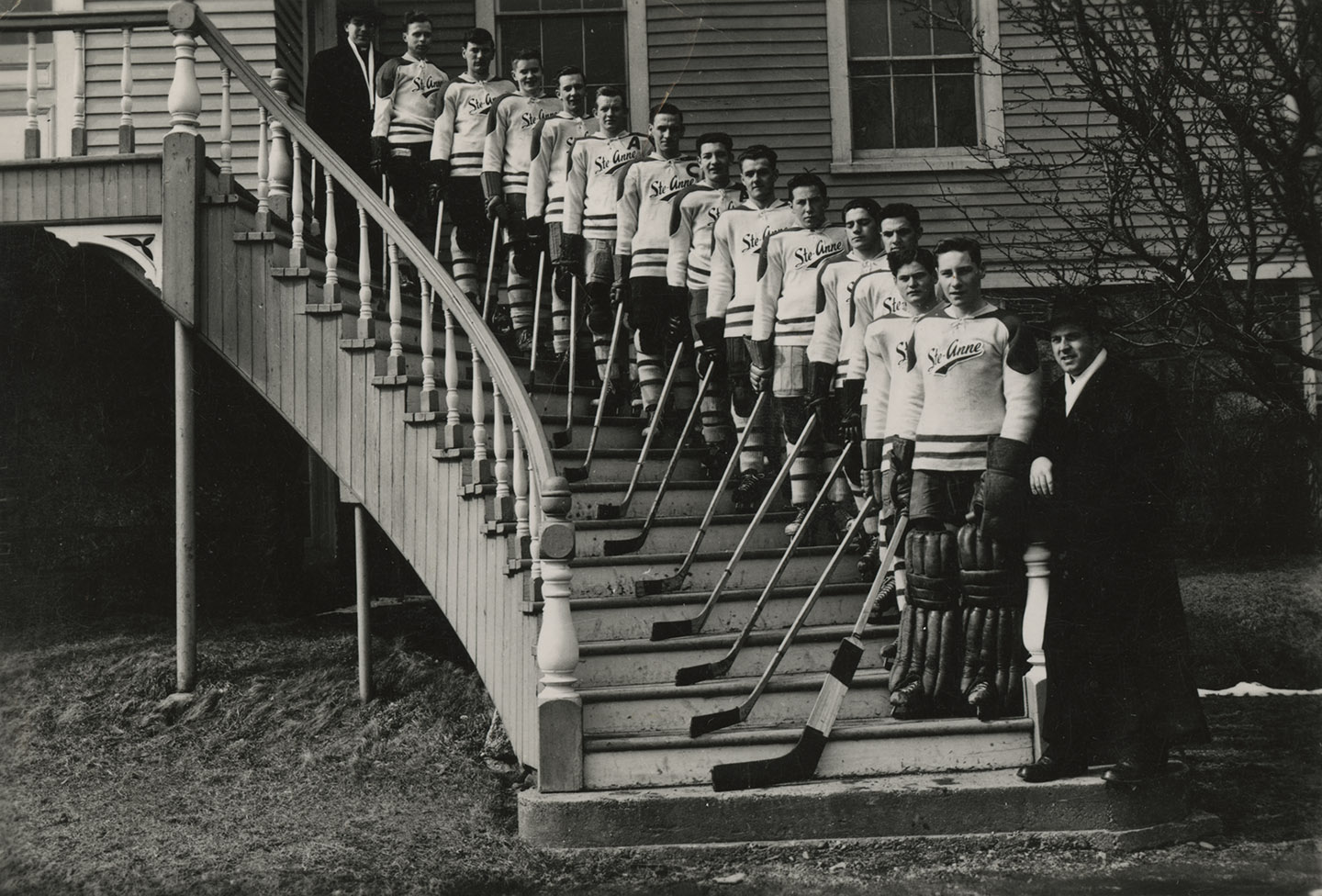 communityalbums - Father Louis Levesque with a hockey team from Université Sainte-Anne, Church Point, NS