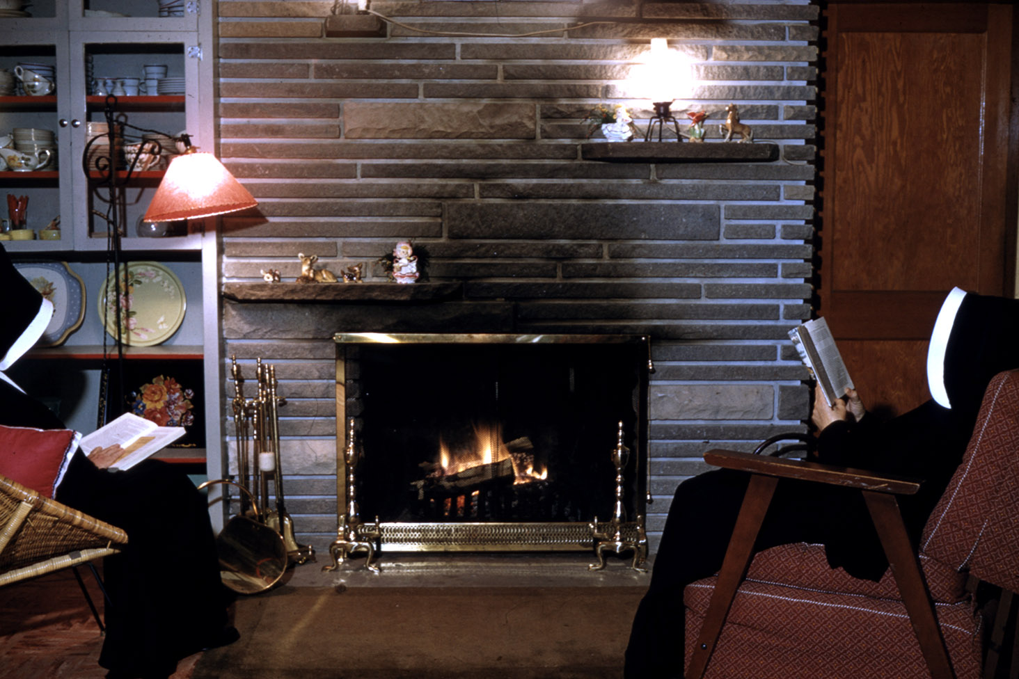 communityalbums - Sisters of Charity-Halifax reading by fire place at Chalet, Grand Lake, Nova Scotia.