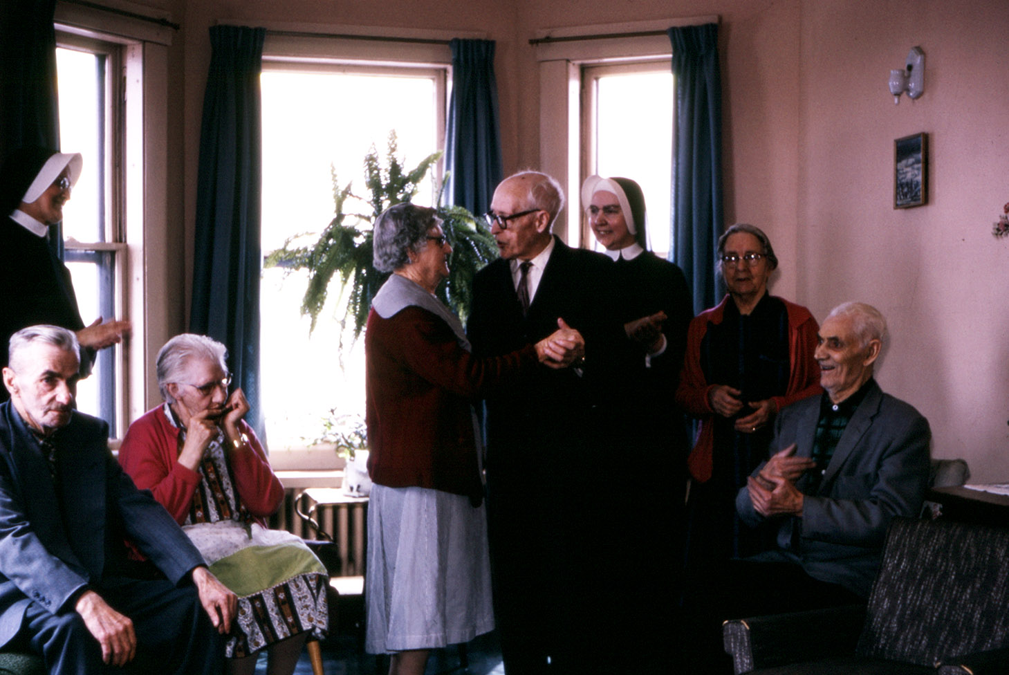 communityalbums - Elderly guests dance to the music of the mouth organ as Sisters of Charity-Halifax watch, Stella Maris Residence, North Sydney, Nova Scotia.