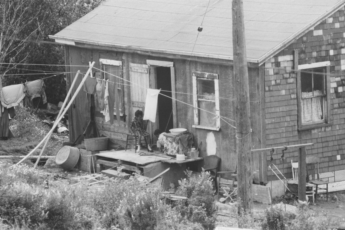 africville : Africville house, with two children on doorstep and laundry hanging on the line