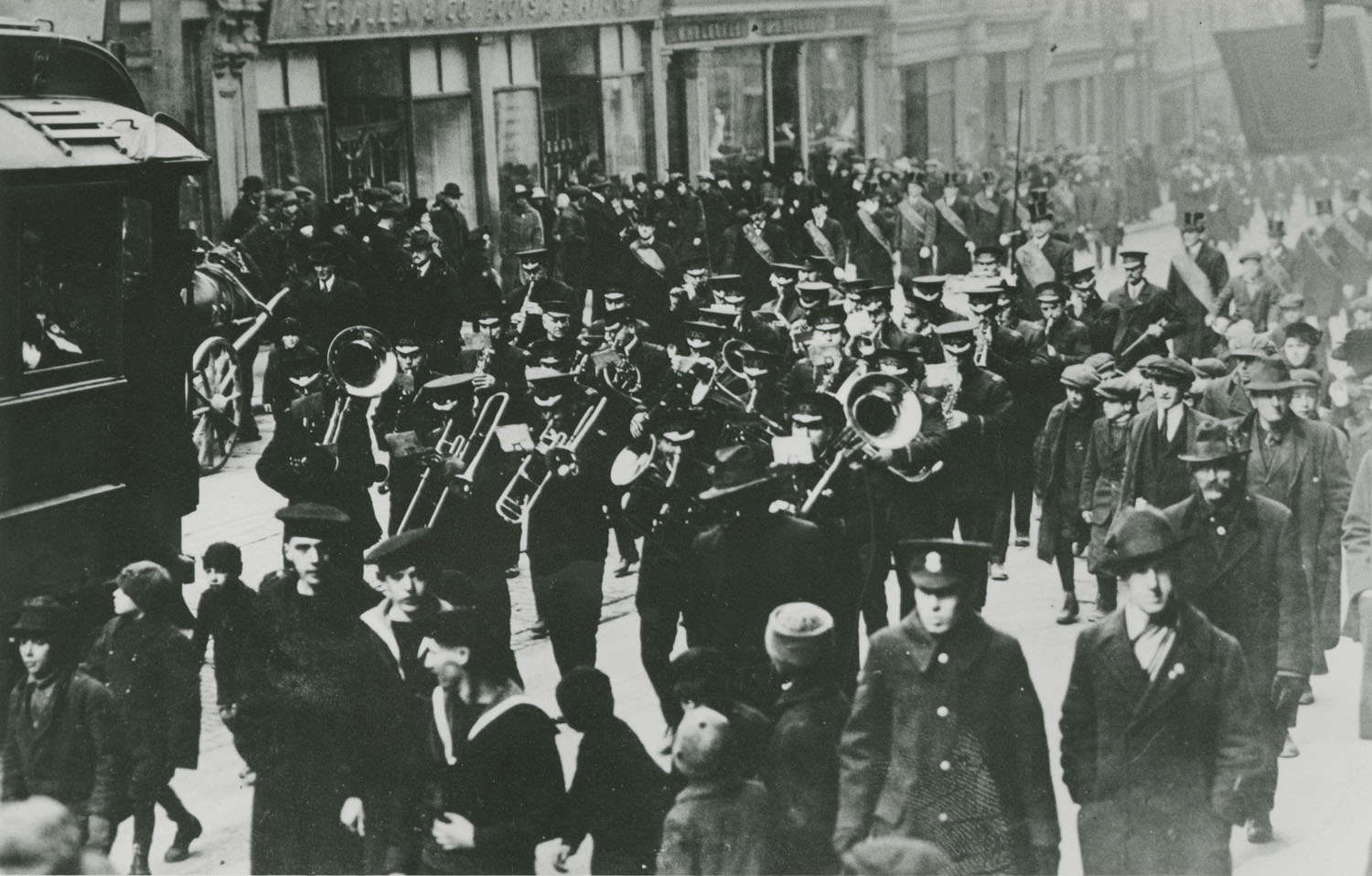 charitable-irish-society : Band in Parade passing T.C. Allen & Co., books, Granville Street, Halifax
