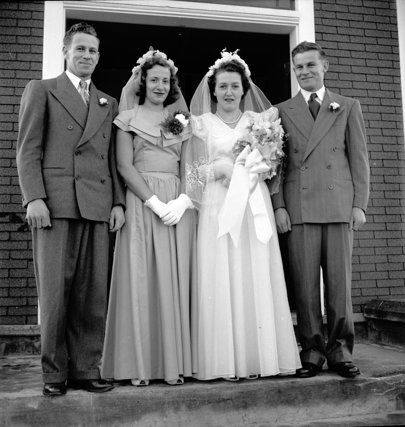 Wedding party in front of the church after the wedding of Evelyn-Theresa Thibodeau and Reed-Henry Melanson. Left to right: Herman Melanson, best man and brother of the groom; Rena Amirault, maid of honour and cousin of the bride; Evelyn-Theresa Thibodeau,