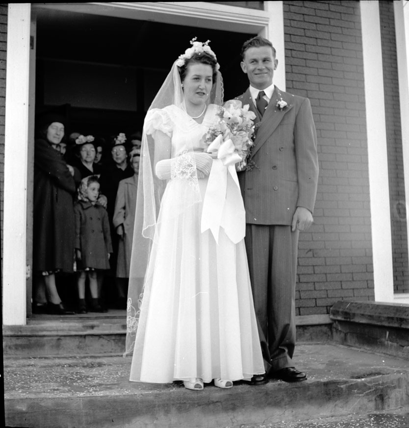 The newly-married couple, Evelyn-Theresa Thibodeau and Reed-Henry Melanson in front of the church. Doucetteville; September 14, 1950