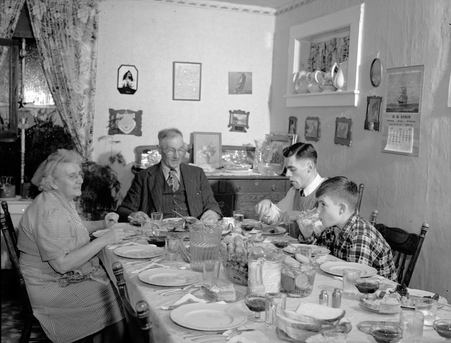 Christmas night dinner at Vian Andrews'. Left to right: Mr. and Mrs. J. Vian Andrews, son John and grandson Harry Thomas. December 1950.