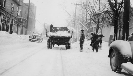 Truck and men shovelling snow on Coburg Road