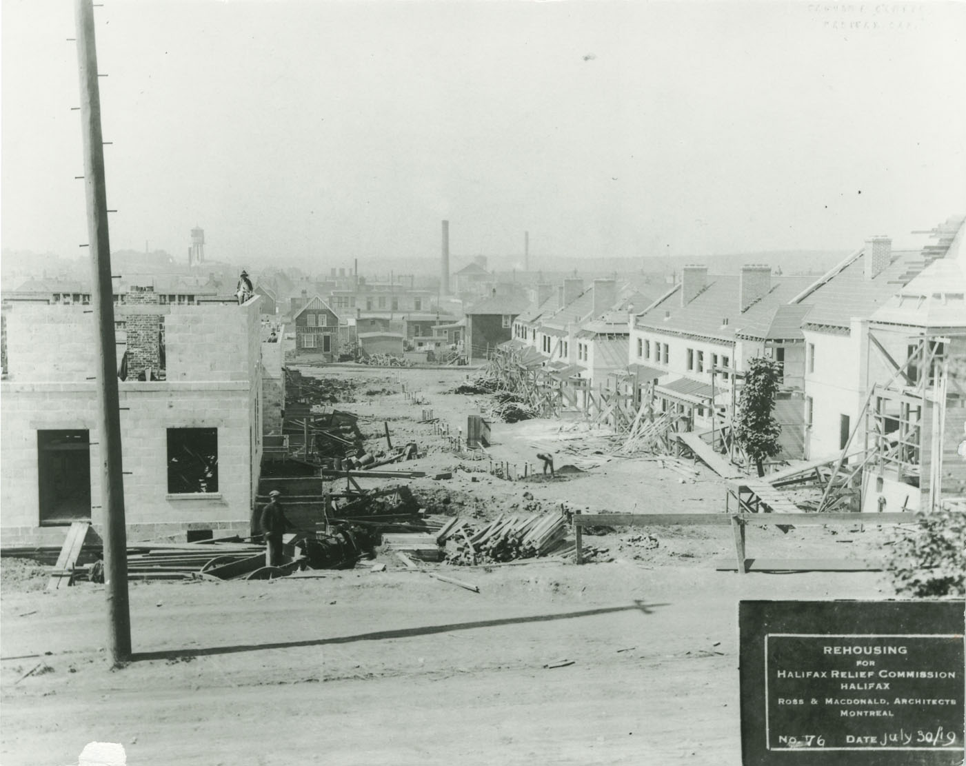 Original photograph copied through the courtesy of Mrs. Shirley Vaughan.      Photograph shows construction of hydrostone housing, Hennessey Court (now Hennessey Place) units at left and Kane Court (now Kane Place) units at right, Halifax.