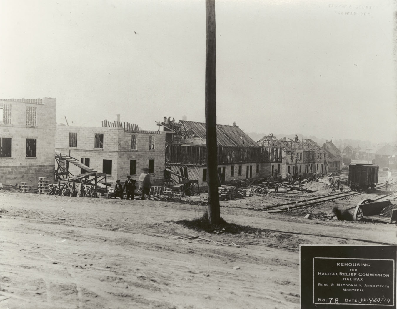 Original photograph copied through the courtesy of Mrs. Shirley Vaughan.      Photograph shows construction of hydrostone housing on Hennessey Court (now Hennessey Place), Halifax.