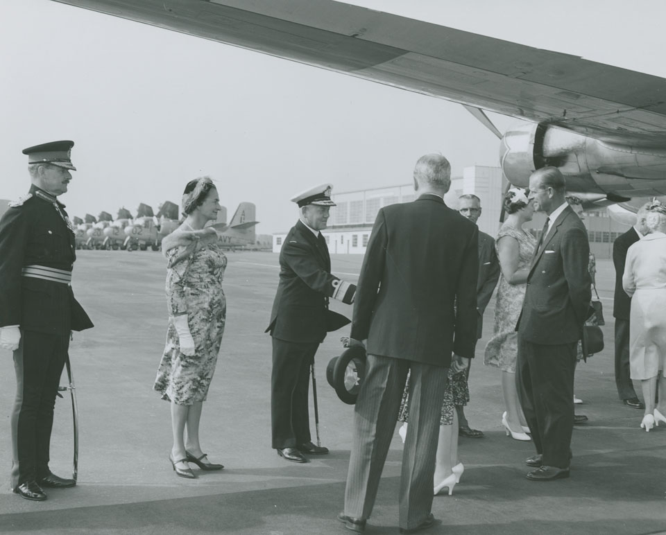 Queen Elizabeth greeting Rear Admiral H.F. Pullen with his wife and Major-General M.P. Bogert looking on