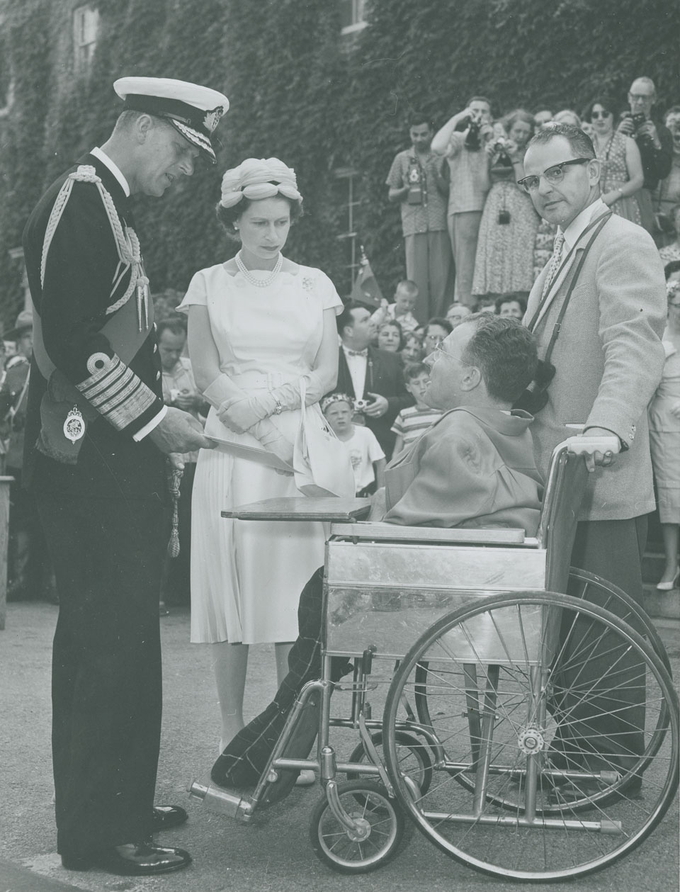 Queen Elizabeth and Prince Philip speaking with Lunenburg artist Earl Bailly at the University of King's College, Halifax