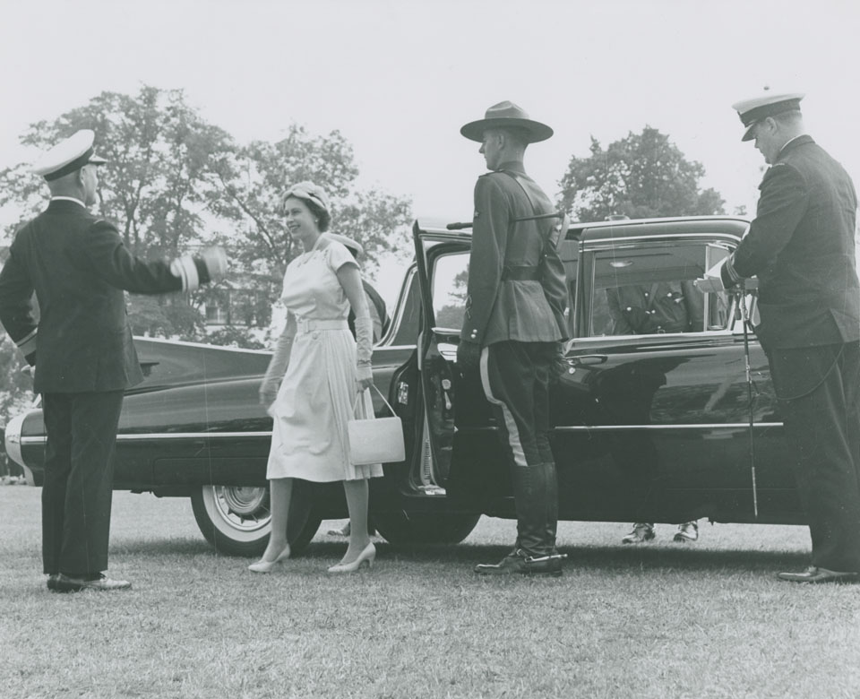 Queen Elizabeth arriving at the Garrison Grounds and greeted by Rear Admiral H.F. Pullen for presentation of new Colours to Royal Canadian Navy