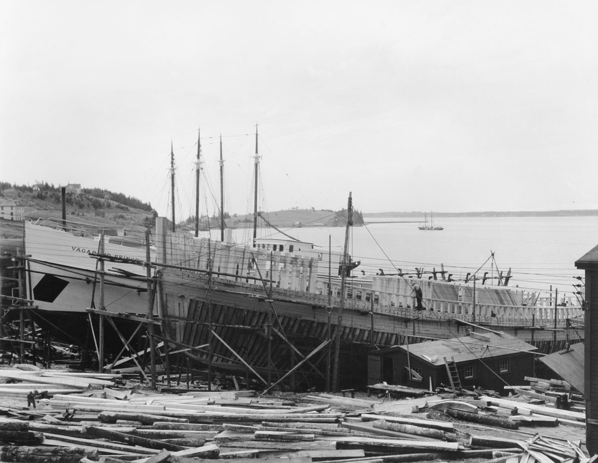 Shipbuilding in Lunenburg showing completed vessel <i>Vagabond Prince</i> and another partially completed in slipways