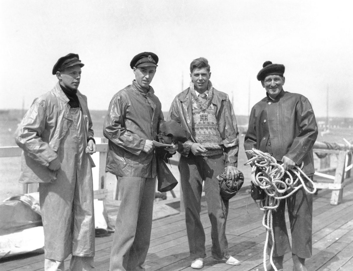 Three unindentified men on wharf with W.R. MacAskill