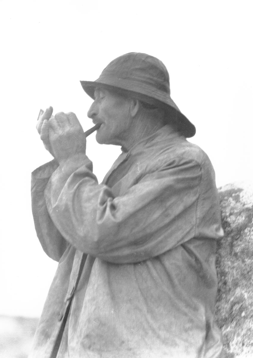 macaskill : Silhouette of Albert Crooks lighting pipe, Peggys Cove, NS