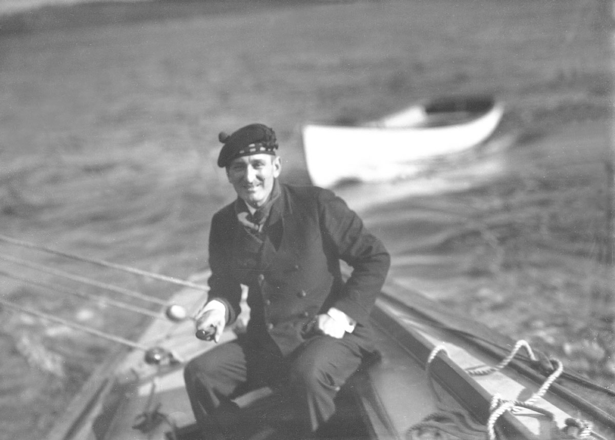 Wallace Robinson MacAskill at tiller of yacht <i>Highlander</i>